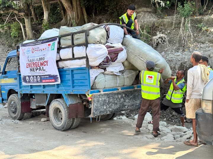 The truck with the “Flash Flood Emergency Nepal” banner brings the tents