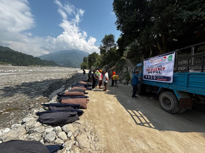 The relief truck on the road beside the river bed
