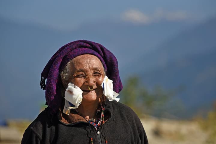 After the operation: an elderly woman smiles, her eye dressings still on