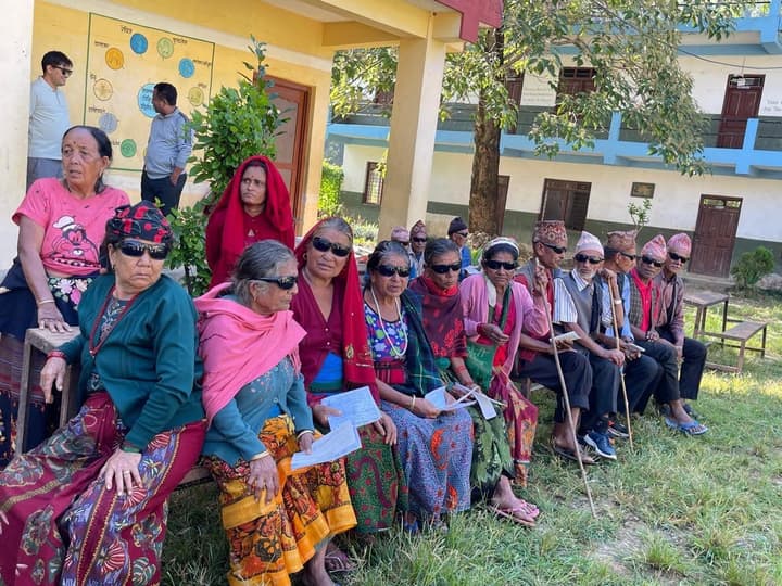 Patients sit side by side in protective sunglasses after their operations