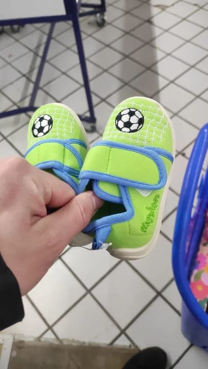 Green children’s shoes with an embroidered football